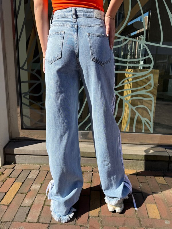 Blauwe jeans met strepen en strik